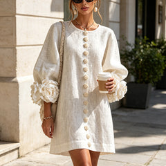 White button-front midi dress with round neckline and puff sleeves featuring rosette details