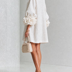 White button-front midi dress, side view, puff sleeves with large rosette cuff details