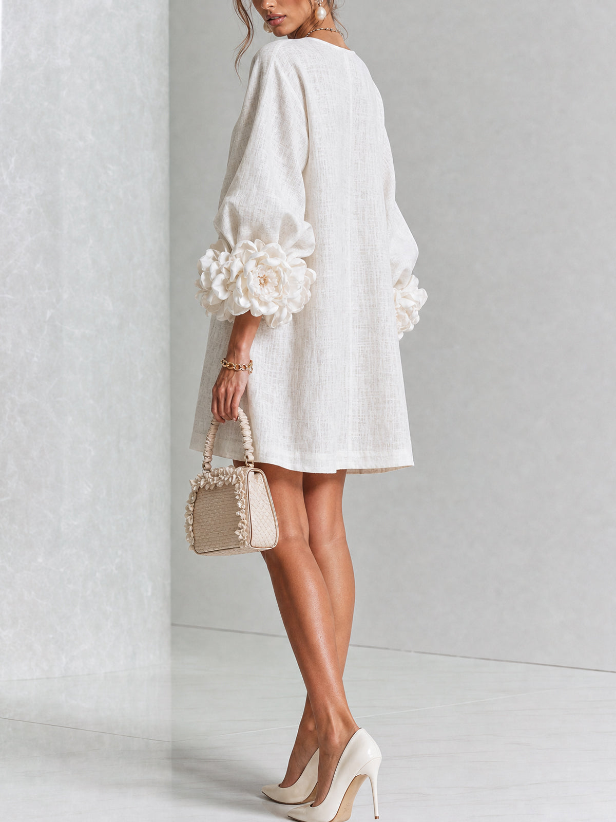 White button-front midi dress, side view, puff sleeves with large rosette cuff details