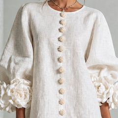 White button-front midi dress close-up, gold decorative buttons and rosette puff sleeves