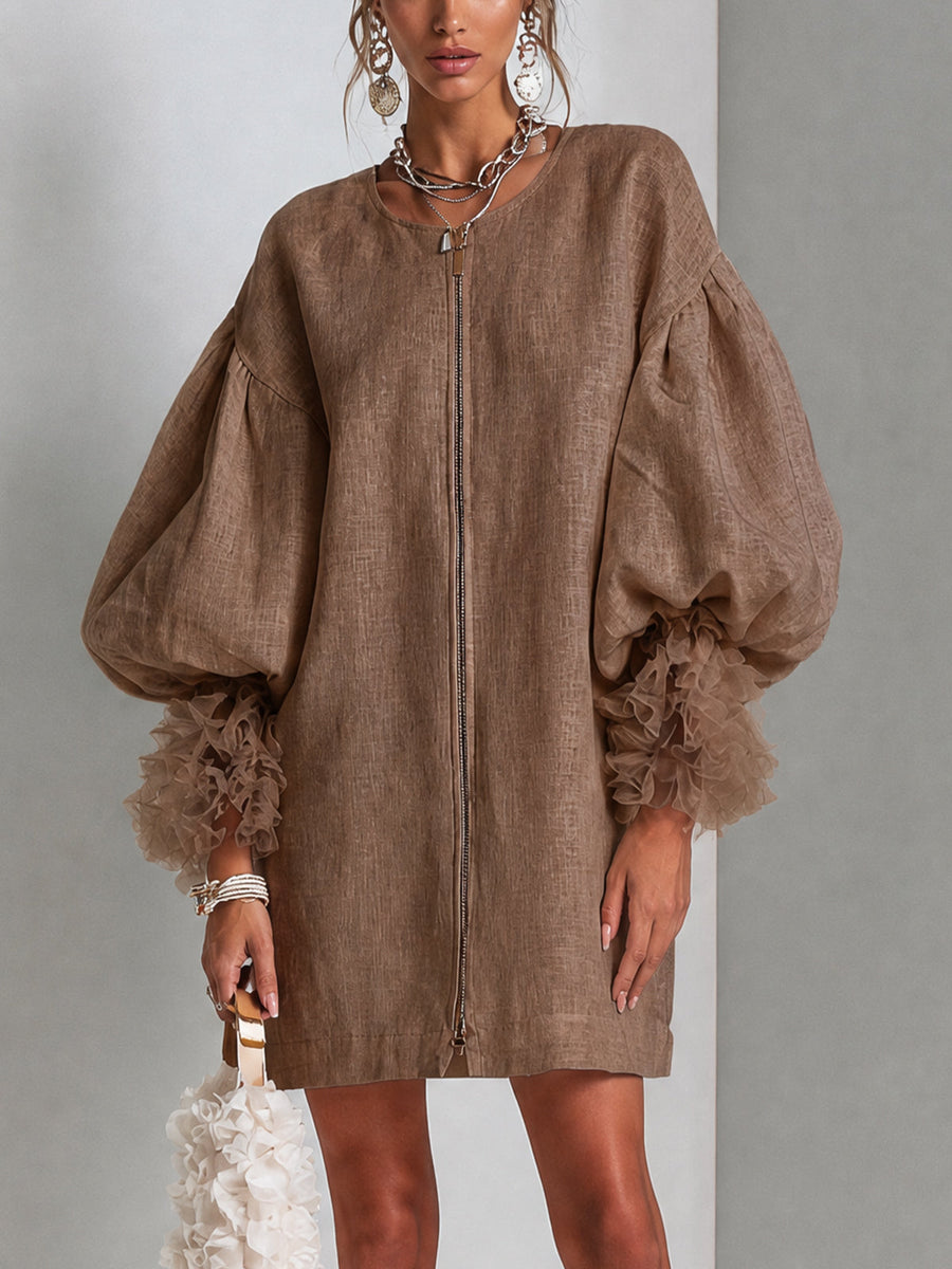 Brown midi dress with front zipper and voluminous balloon sleeves with ruffled cuffs.