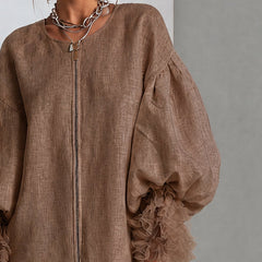 Brown linen-look midi dress with front zipper and ruffled balloon sleeve cuffs.