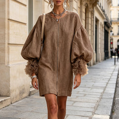 Brown zip-front midi dress with exaggerated balloon sleeves and ruffled cuffs, relaxed fit.