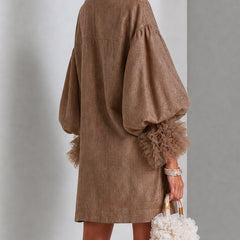 Brown midi dress with zip front, wide shoulders, and ruffle-trimmed balloon sleeves.