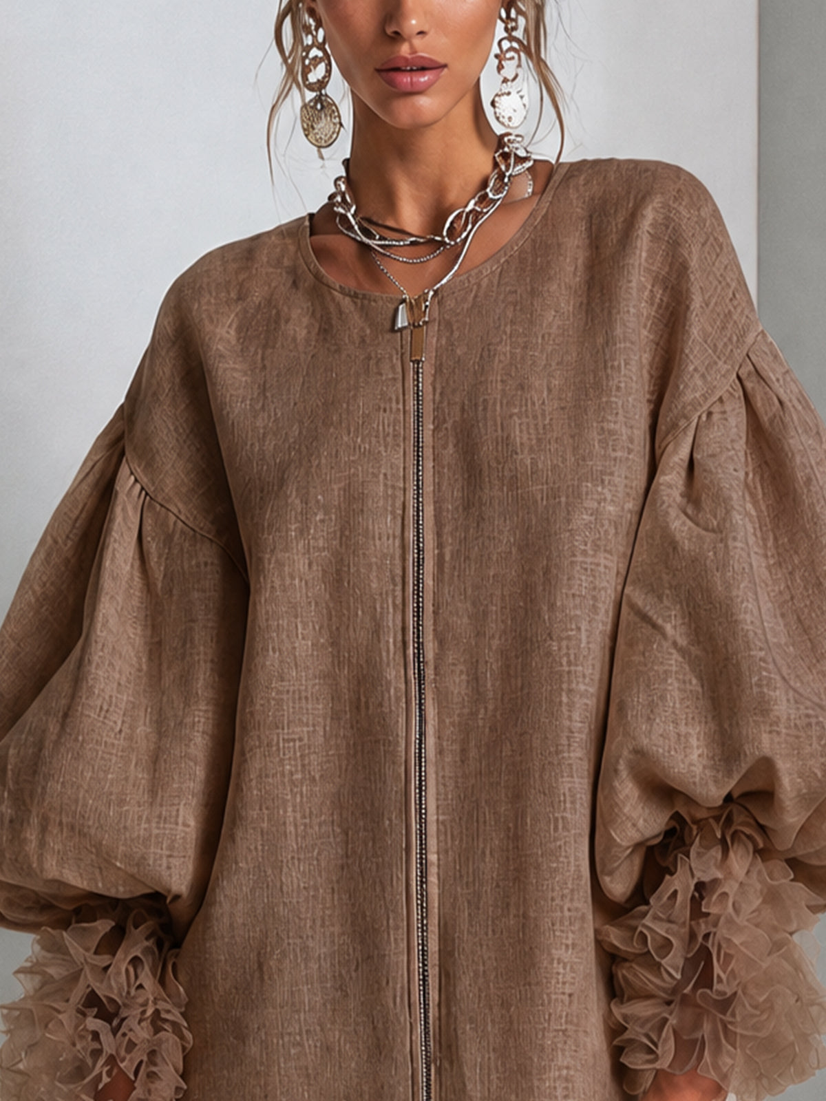 Brown zip-front midi dress with round neckline and wide balloon sleeves with ruffle cuffs.
