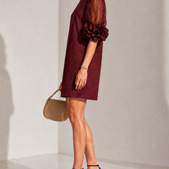 Burgundy short-sleeve dress with sheer puff sleeves and rosette detail