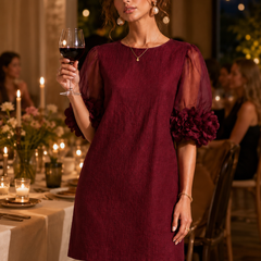 Burgundy puff-sleeve midi dress with sheer sleeves and pom-pom rosette cuffs