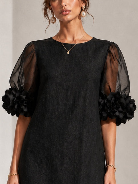 Black midi dress with sheer puff sleeves and rosette cuffs, crew neckline detail.