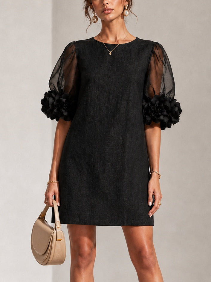 Black midi dress with sheer puff sleeves and rosette cuffs, crew neckline.