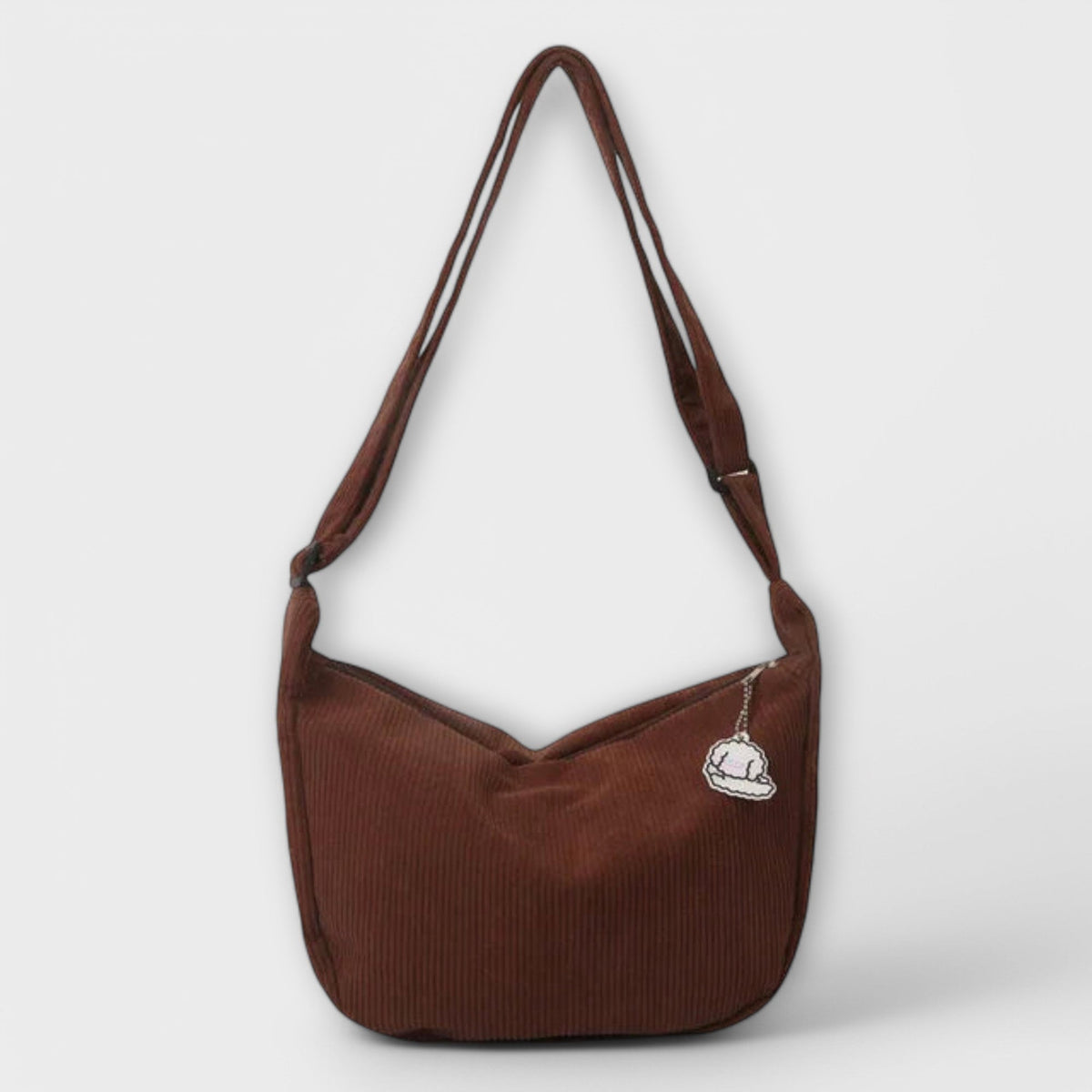 Women’s dark brown shoulder bag with curved hobo shape and white logo patch
