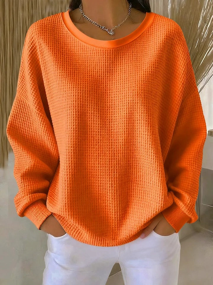NYLA classic sweater in orange waffle-knit, crewneck, long sleeves with ribbed cuffs.