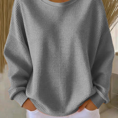 NYLA classic sweater in grey waffle-knit, crewneck, long sleeves with ribbed cuffs.