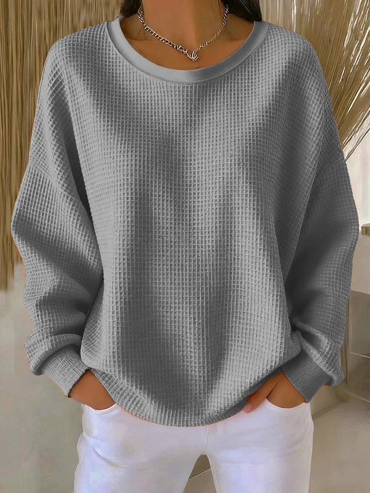 NYLA classic sweater in grey waffle-knit, crewneck, long sleeves with ribbed cuffs.