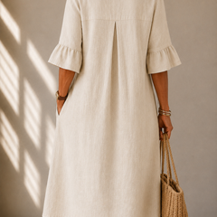 Light beige midi dress, back view with keyhole slit and three-quarter ruffle sleeves
