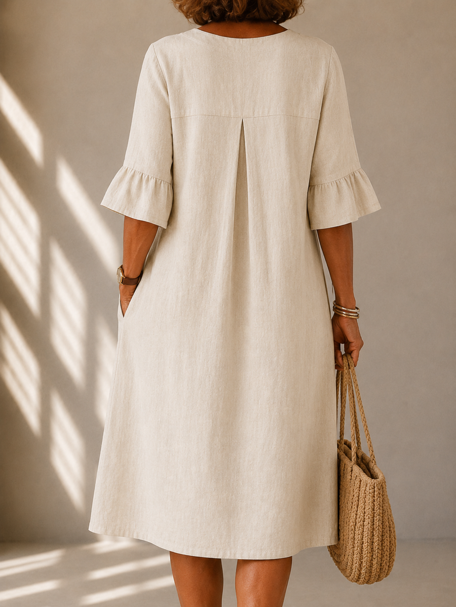 Light beige midi dress, back view with keyhole slit and three-quarter ruffle sleeves