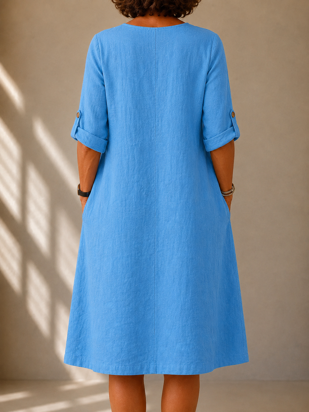Blue V-back midi dress with three-quarter sleeves, relaxed A-line silhouette