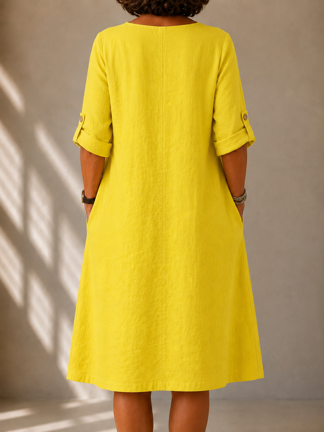 Back view of yellow relaxed V-neck midi dress with 3/4 sleeves