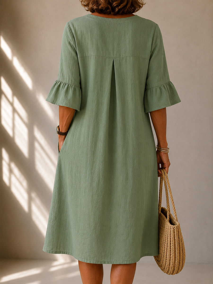 Back of sage green midi dress with pleated yoke and gathered bell sleeves