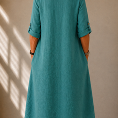 Teal midi dress with rounded back neckline, 3/4 sleeves, and draped skirt
