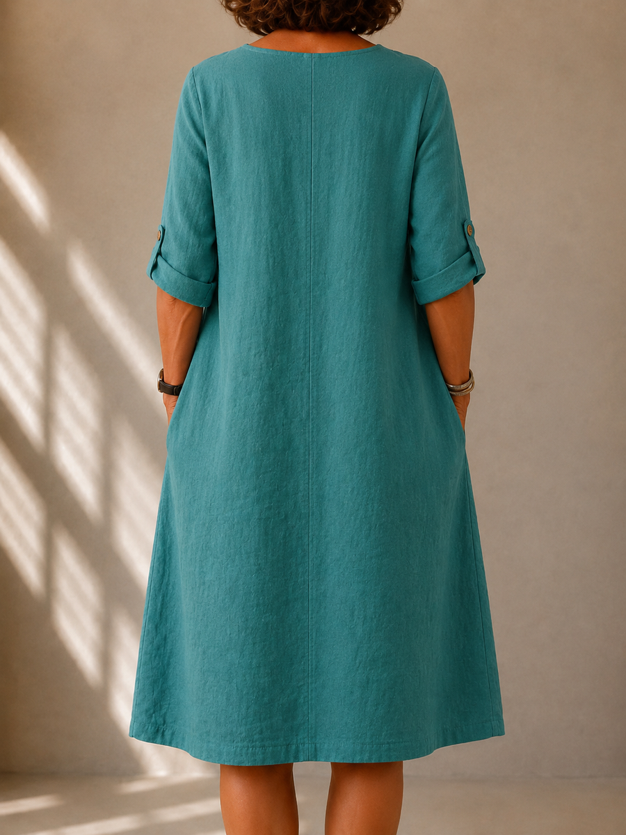 Teal midi dress with rounded back neckline, 3/4 sleeves, and draped skirt