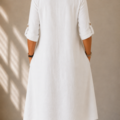 White midi dress back view with 3/4 sleeves and buttoned cuff details