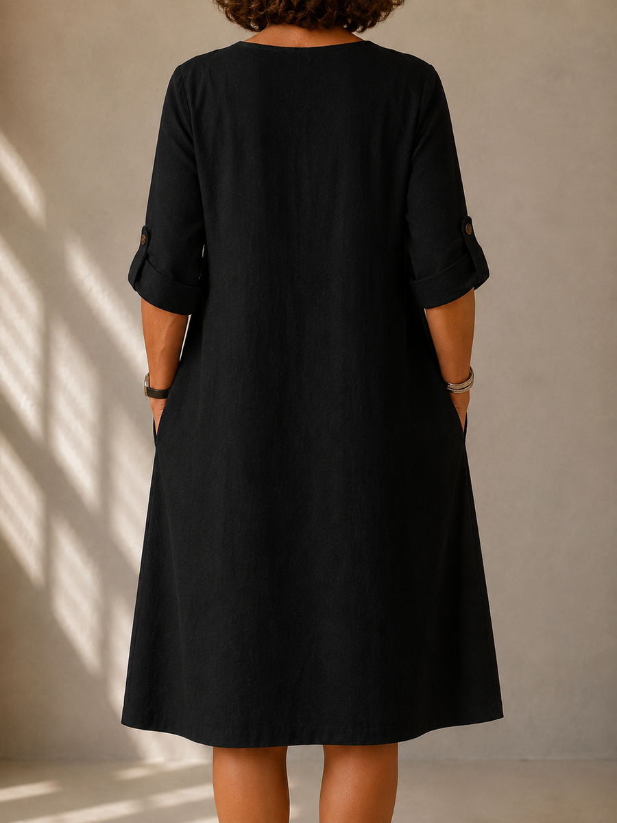 Black midi dress back view with elbow-length sleeves and gathered cuffs