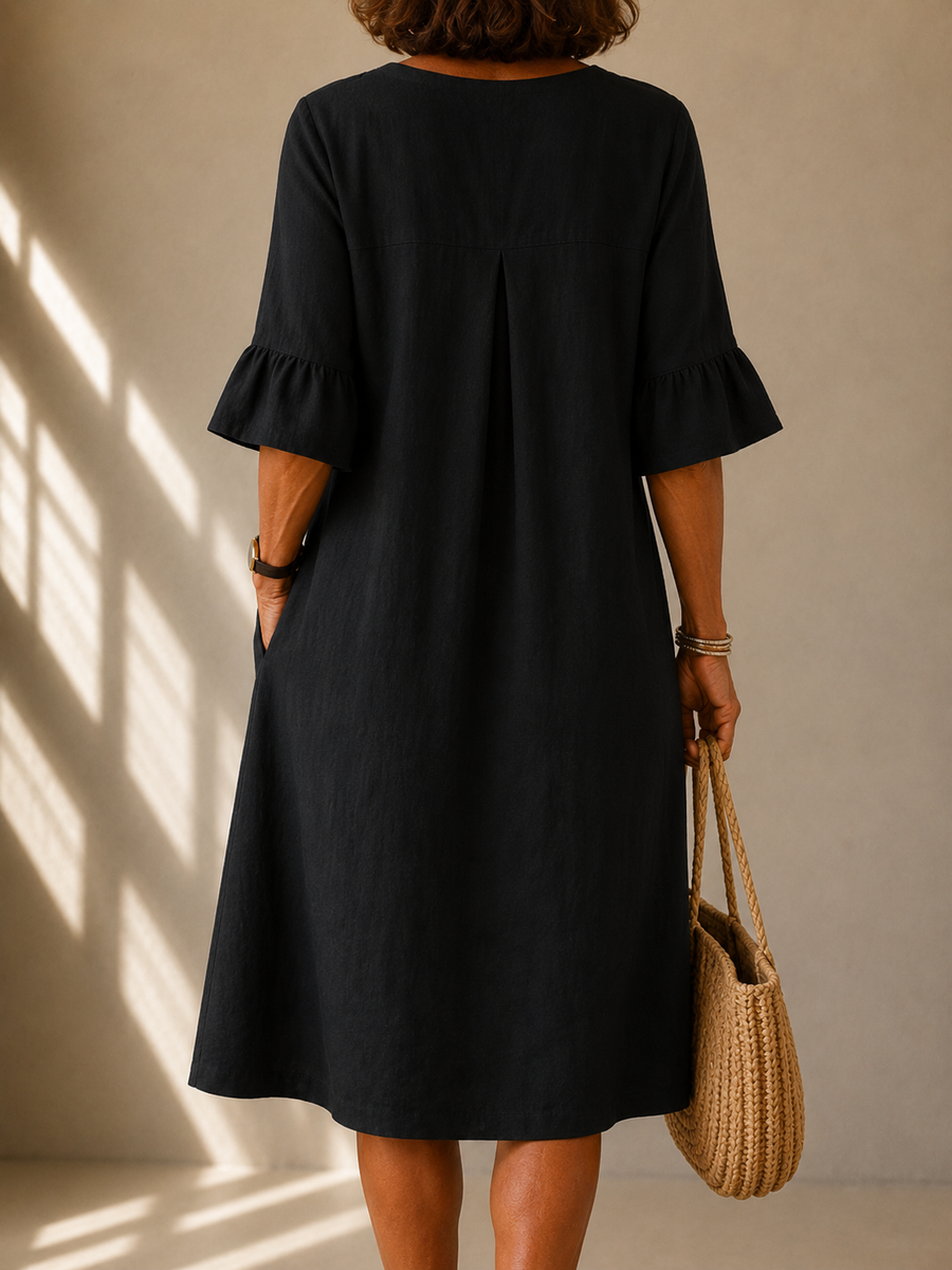 Black midi dress, back view with gathered yoke and short bell sleeves