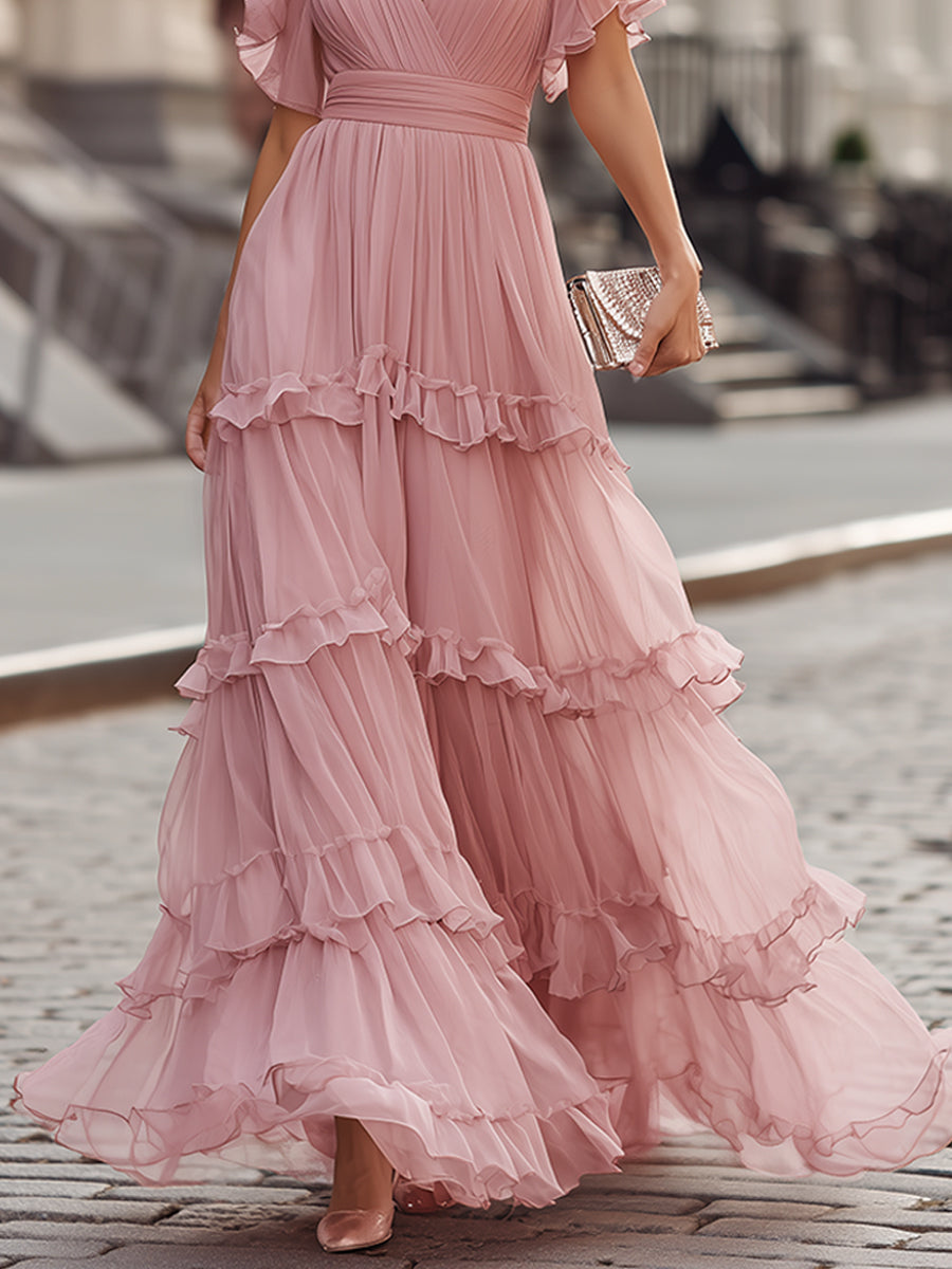 Pink tiered maxi dress with ruffled V-neck, short flutter sleeves and layered skirt