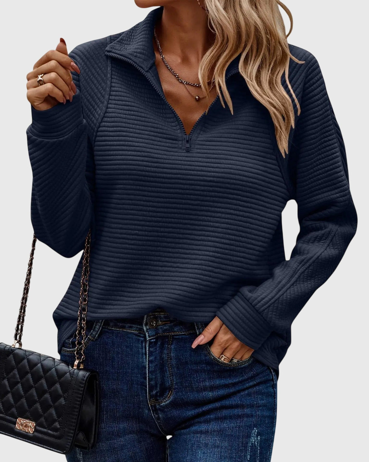 Women’s dark blue ribbed knit quarter-zip jumper with long sleeves and seam detail.