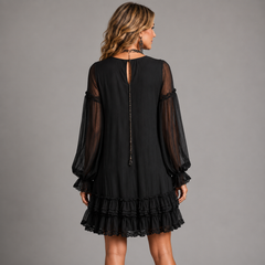 Black mini dress back view with sheer sleeves and open-back tie detail