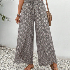 Grey wide-leg trousers with shirred waist, repeating micro pattern, full length.