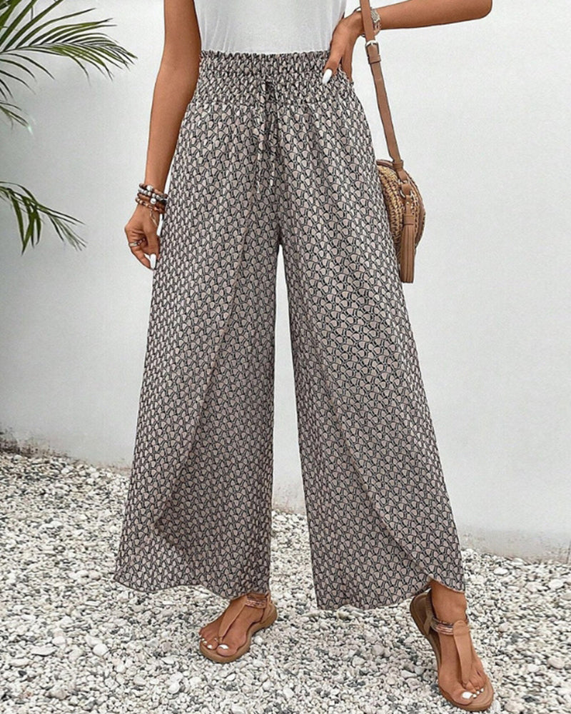 Grey wide-leg trousers with shirred waist, repeating micro pattern, full length.
