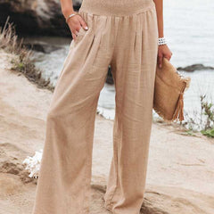 Beige wide-leg trousers with shirred waistband, relaxed pleated front