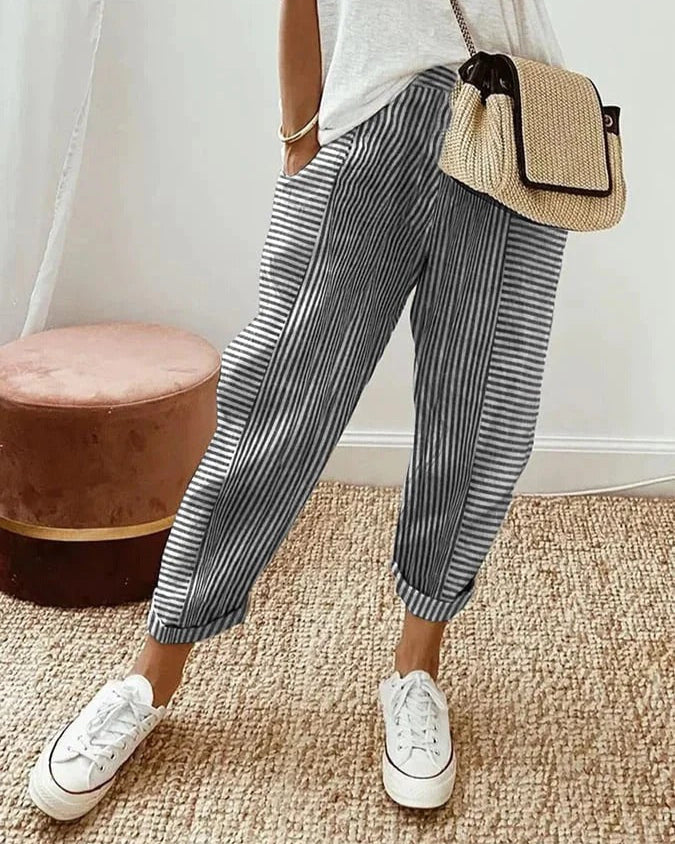 Classic striped trousers, dark with white vertical stripes and cuffed hems