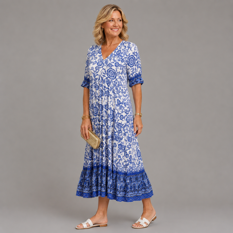 Blue floral V-neck midi dress with short sleeves and tiered hem, side view