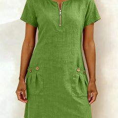 Abito in cotone verde con zip frontale e due tasche laterali con bottoni
