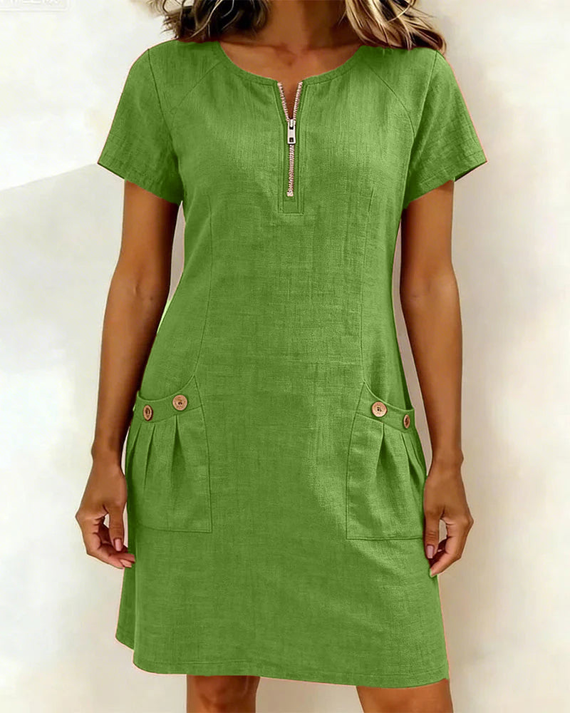 Abito in cotone verde con zip frontale e due tasche laterali con bottoni