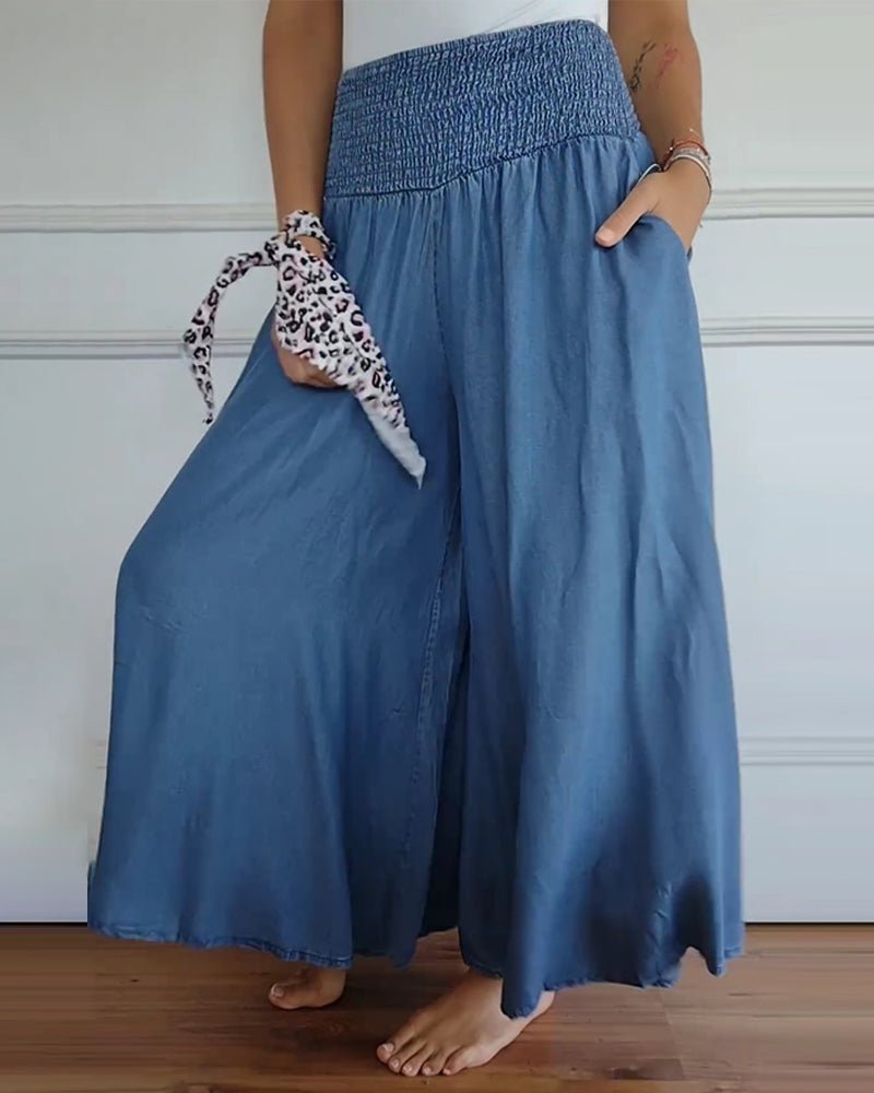 Blue relaxed-fit trousers with elastic waist, wide legs and side seam detail
