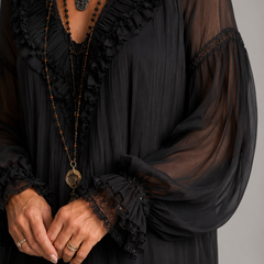 Black V-neck mini dress with gathered texture, ruffled neckline trim and sheer sleeves
