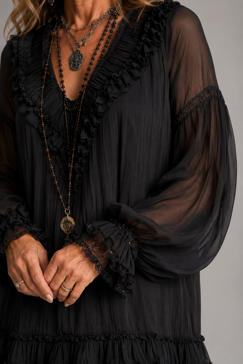 Black V-neck mini dress with gathered texture, ruffled neckline trim and sheer sleeves