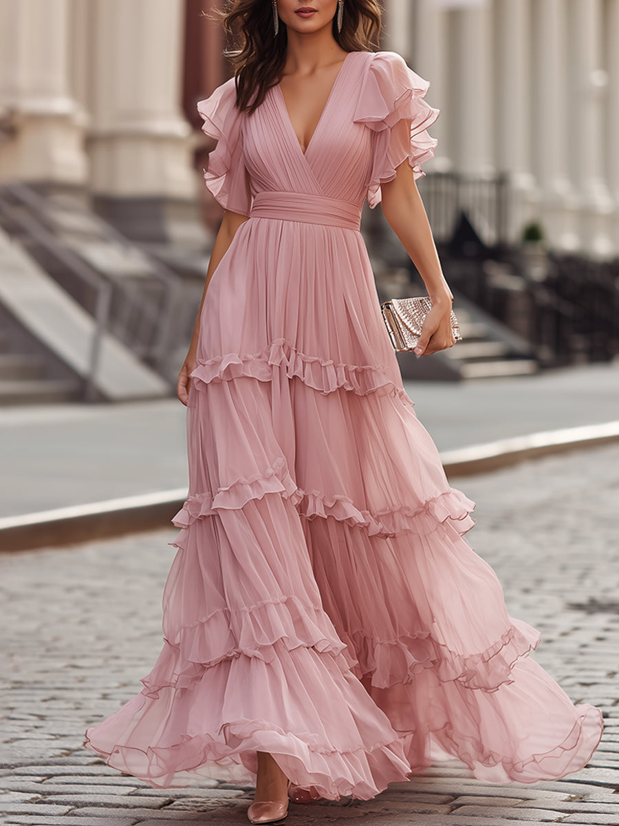 Pink ruffled tiered maxi dress with V-neck bodice and flutter sleeves, full layered skirt