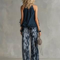 Two-piece halter ruffle top and wide-leg printed pants set, back view with layered hem