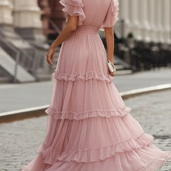 Pink tiered maxi dress with flutter sleeves and layered skirt, back neckline visible