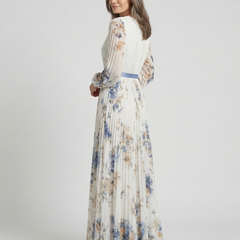White floral long sleeve V-neck maxi dress, side view, pleated skirt and blue sash