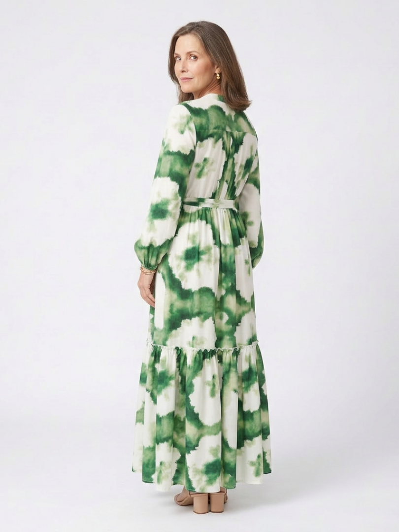 Back view of green-and-white tie-waist tiered maxi dress with long sleeves and floral print