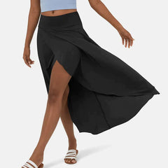 Asymmetric midi skirt in black with high-low hem and draped side panel