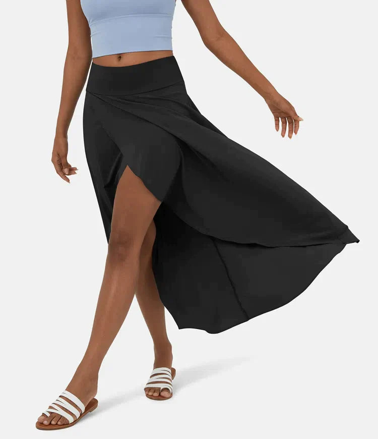 Asymmetric midi skirt in black with high-low hem and draped side panel