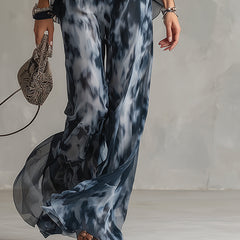 Wide-leg printed pants in dark blue and gray, flowing drape and loose fit