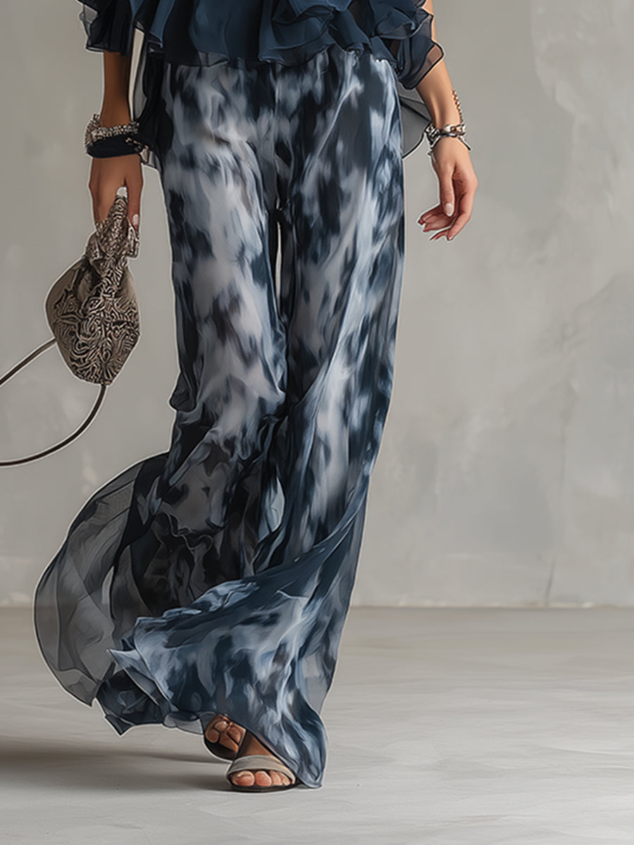 Wide-leg printed pants in dark blue and gray, flowing drape and loose fit