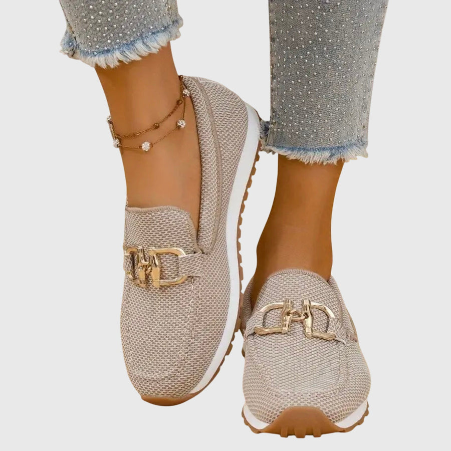 Beige orthopaedic loafer trainer with gold horsebit-style strap, textured knit and cushioned sole